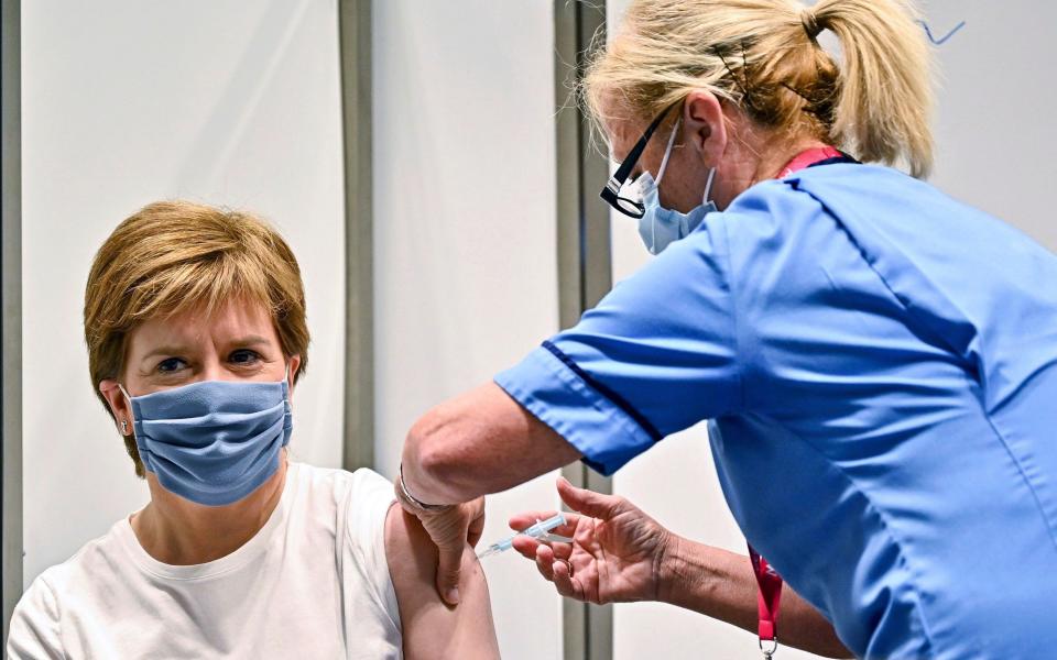 First Minister of Scotland Nicola Sturgeon receives her second dose of the AstraZeneca Covid-19 vaccine, administered by staff nurse Susan Inglis, at the NHS Louisa Jordan vaccine centre in Glasgow, Scotland, - PA