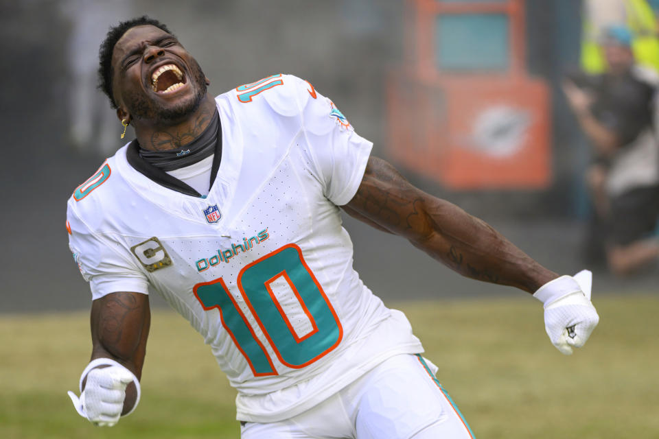 Miami Dolphins wide receiver Tyreek Hill (10) reacts as he runs onto the field during player introductions before an NFL football game against the Las Vegas Raiders, Sunday, Nov. 19, 2023, in Miami Gardens, Fla. (AP Photo/Doug Murray)