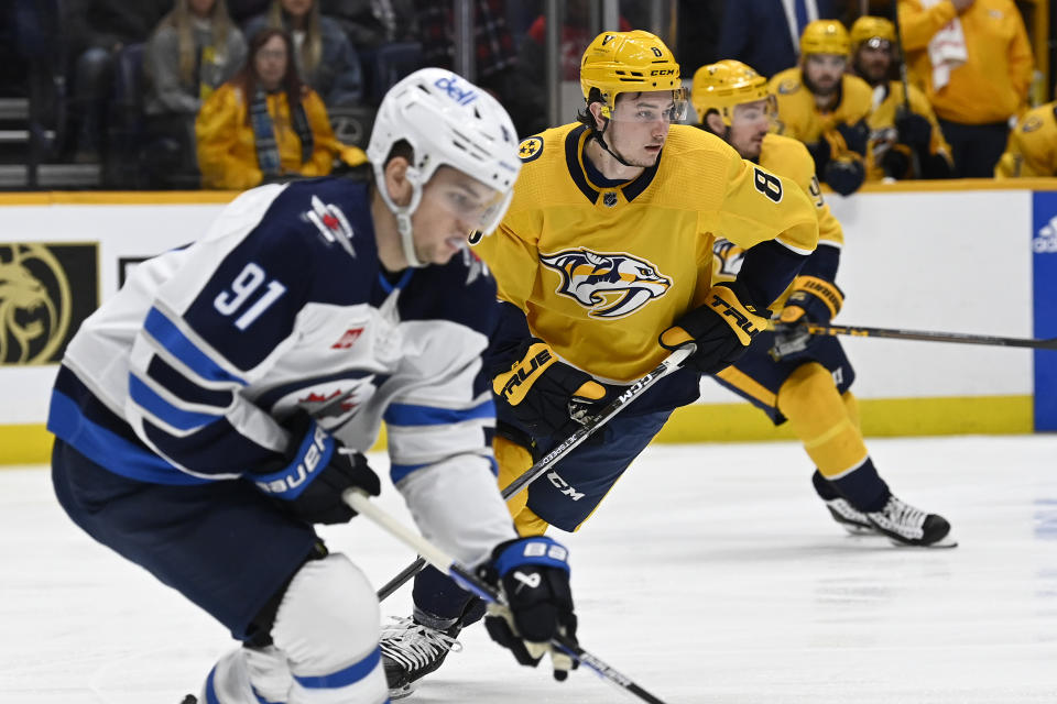 Nashville Predators center Cody Glass (8) plays against Winnipeg Jets center Cole Perfetti (91) during the first period of an NHL hockey game Tuesday, Jan. 24, 2023, in Nashville, Tenn. (AP Photo/Mark Zaleski)