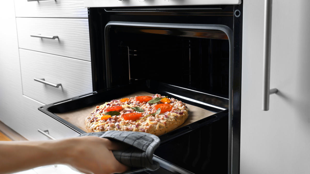 Why You Should Always Place A Baking Sheet Under Food In The Oven