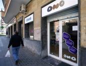 A man walks past an Ono shop in Mataro, near Barcelona March 17, 2014. REUTERS/Albert Gea