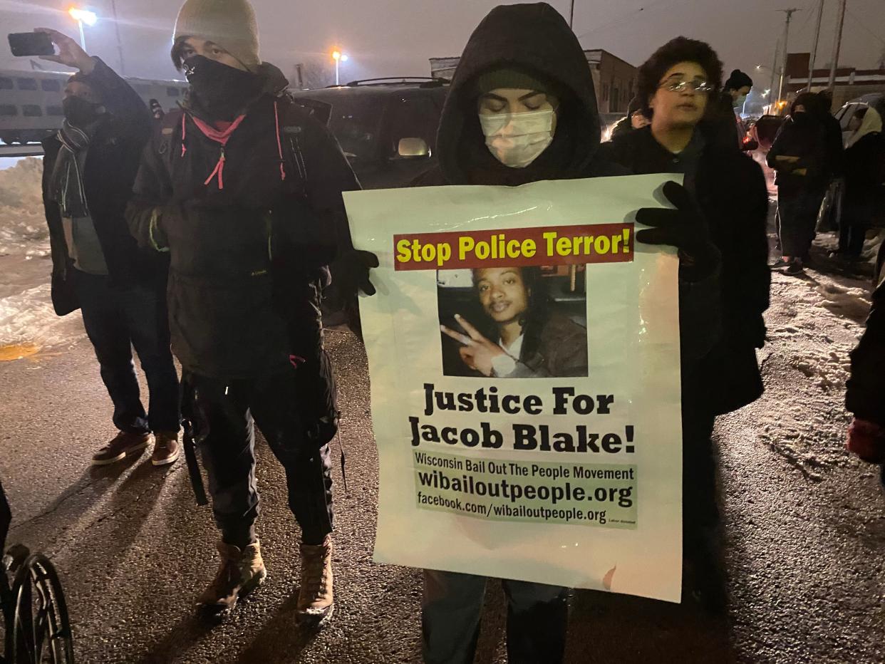 Protestors march through Kenosha after the District Attorney announced he wouldn't charge the police officers involved in the Jacob Blake shooting