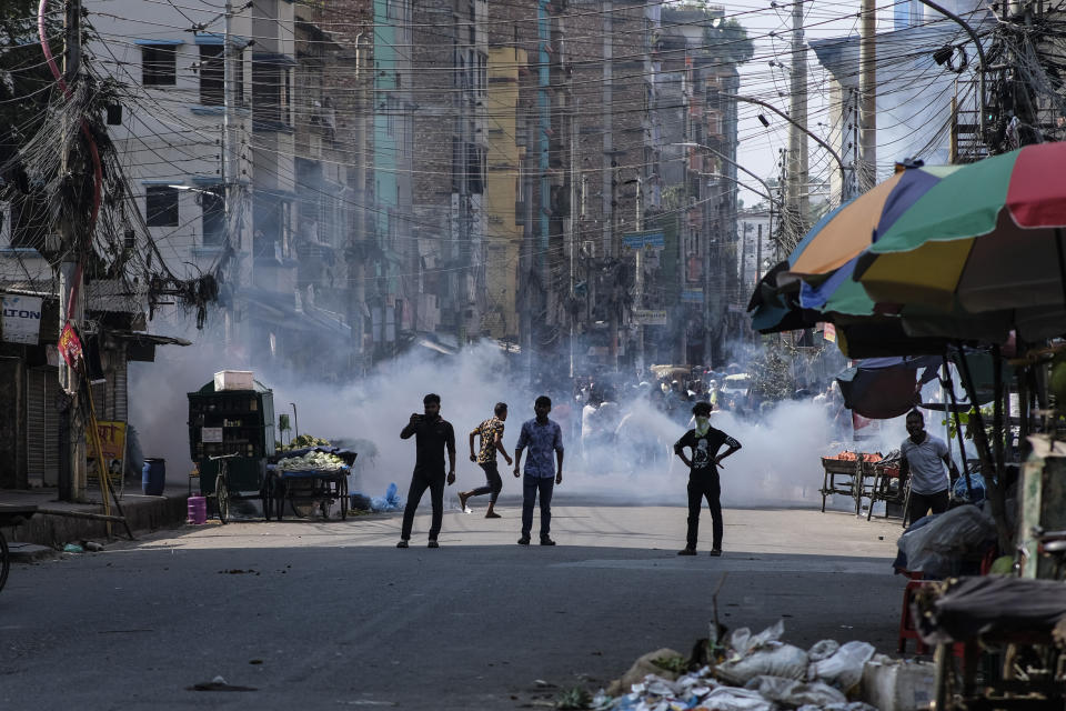 Police fire tear gas shells to disperse Bangladeshi garment factory workers who were blocking traffic demanding better wages at Dhaka-Mirpur area in Bangladesh, Thursday, Nov.2, 2023. (AP Photo/Mahmud Hossain Opu)