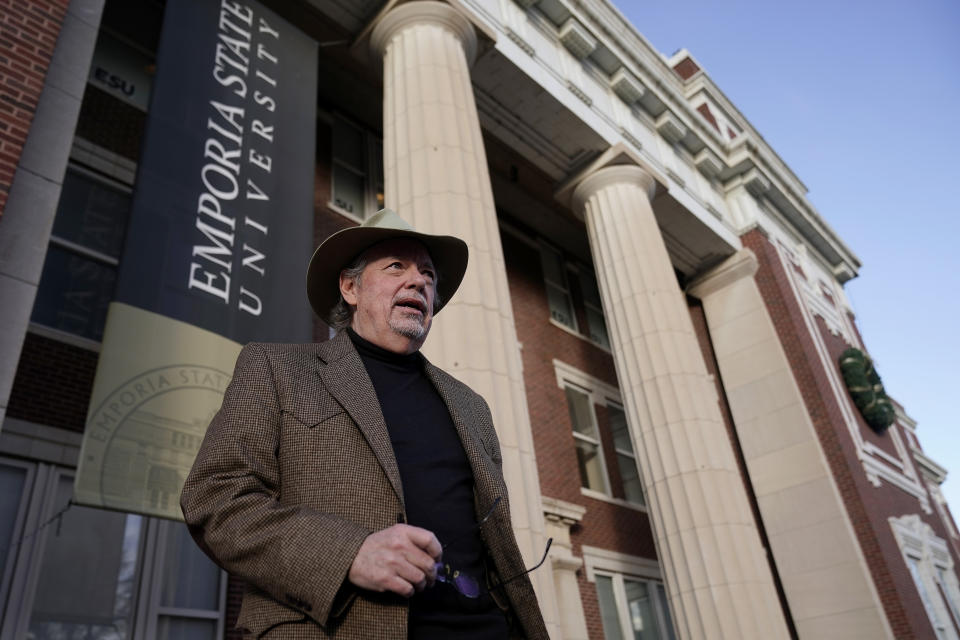 Max McCoy, the lone journalism professor at Emporia State University, talks about his dismissal in front of the school's administration building Wednesday, Jan. 4, 2023, in Emporia, Kan. McCoy penned a column that began, “I may be fired for writing this” — before learning this would be his last year teaching at the school. “This is a purge,” he said. He said all the fired professors were “Democrats or liberal in our thinking.” (AP Photo/Charlie Riedel)