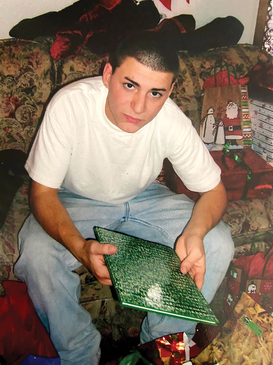 Colton Shrag, age 16 on a home visit from Agapé in 2008. Shrag is holding an Agape year book. It is one of the 2 times he saw his family between 2006 and 2010. The last time would be his graduation.