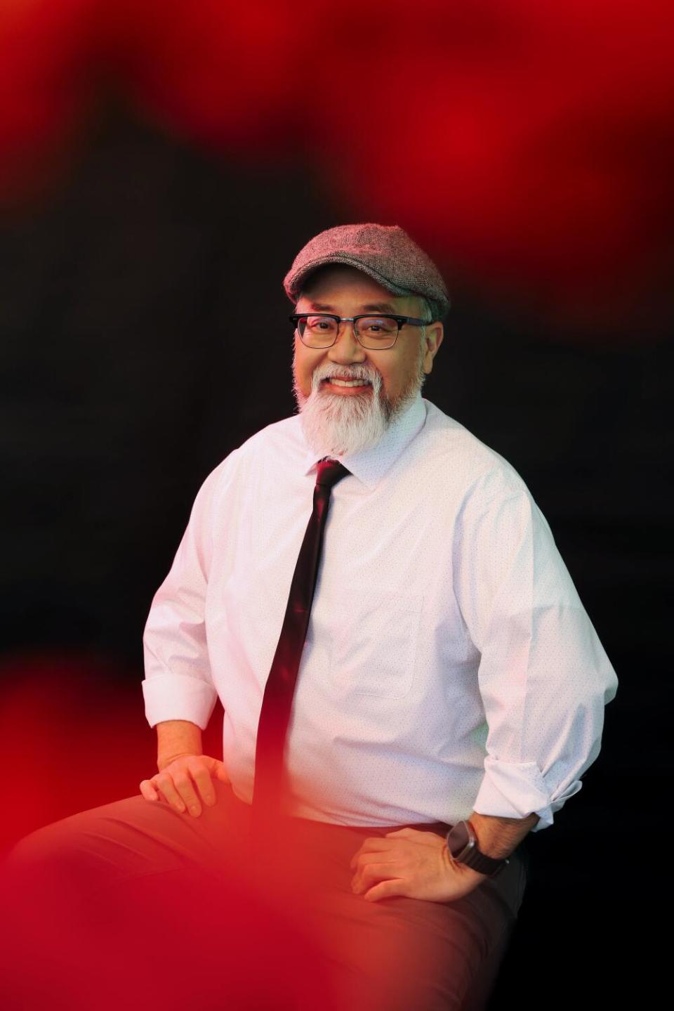 Paul Sun-Hyung poses for a portrait in a white collared shirt and tie