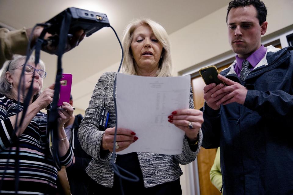 Mesa County Clerk Tina Peters, center, reads the results from the first round of ballots for the 2020 presidential primary elections at the Mesa County election office in Grand Junction, Colo., on March 3, 2020. The county’s election equipment has been decertified and will have to be replaced following a security breach allegedly aided by Peters.