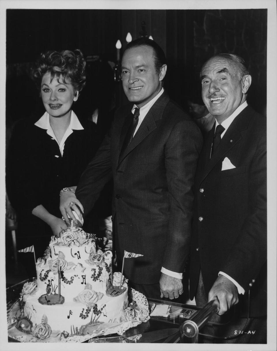 <p>Presumably at the wrap party, Lucille, her costar Bob Hope, and producer Jack L Warner cut into a celebratory cake. This movie marked the last of four feature films the actors starred in together.</p>