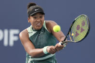 Naomi Osaka, of Japan, hits a return to Caroline Garcia, of France, during the Miami Open tennis tournament, Sunday, March 24, 2024, in Miami Gardens, Fla. (AP Photo/Lynne Sladky)