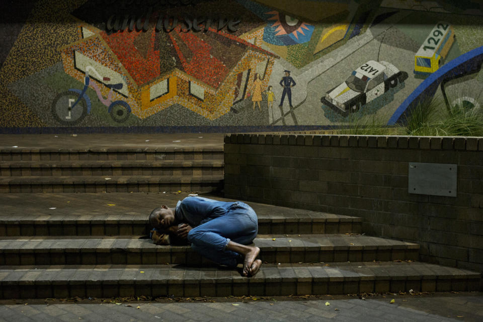 FILE - In this Sept. 19, 2017, file photo, a homeless man sleeps curled up on the steps of a police station in Los Angeles' Skid Row area, home to the nation's largest concentration of homeless people. California has spent $13 billion in the last three years to tackle a massive homelessness problem likely to worsen with the pandemic, yet its approach is so disjointed and incomplete as to hinder efforts at getting people into stable housing, the state auditor said in a report released Thursday, Feb. 11, 2021. (AP Photo/Jae C. Hong, File)