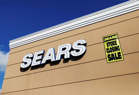 FILE PHOTO: A store closing sale sign is posted next to a Sears logo in New Hyde Park, New York, on Oct. 10, 2018. REUTERS/Shannon Stapleton/File Photo