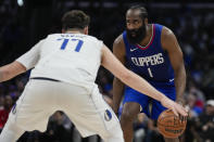 Dallas Mavericks guard Luka Doncic (77) defends against LA Clippers guard James Harden (1) during the first half of Game 1 of an NBA basketball first-round playoff series in Los Angeles, Sunday, April 21, 2024. (AP Photo/Ashley Landis)