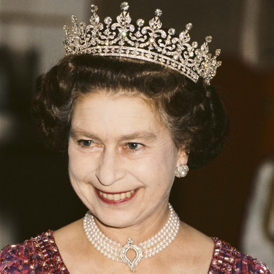 Queen Elizabeth II pictured wearing a four strand diamond and pearl choker with 'Granny's Tiara' in November 1983 - Hulton Royals Collection