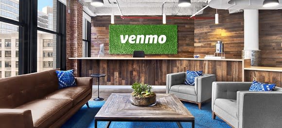 Interior of contemporary office with large "Venmo" signage in entrance lounge.