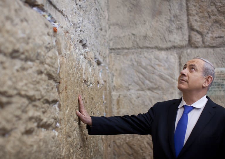 Israeli Prime Minister Benjamin Netanyahu prays at the Western Wall, Judaism's holiest prayer site, in Jerusalem's Old City, on January 22, 2013, as Israeli went to the polls in its 19th general election