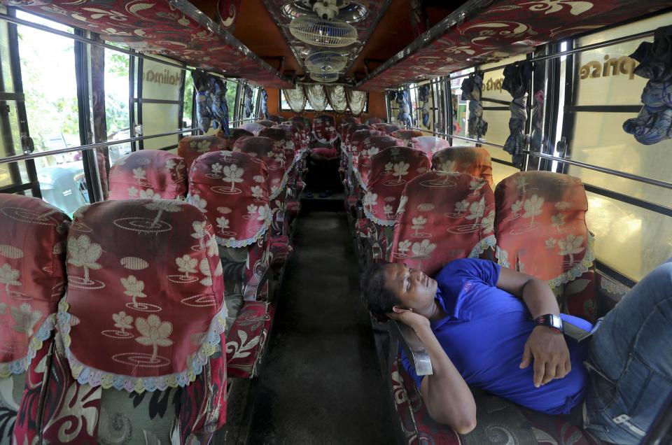 Driver of a bus that was brought to take Rohingya refugees to the Myanmar border takes rest inside the bus outside Nayapara Rohingya refugee camp in Cox's Bazar, Bangladesh, Thursday, Aug.22, 2019. Bangladesh's refugee commissioner said Thursday that no Rohingya Muslims turned up to return to Myanmar from camps in the South Asian nation. (AP Photo/Mahmud Hossain Opu)