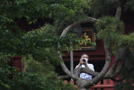 A man wearing a protective mask to help curb the spread of the new coronavirus takes photos Tuesday, June 2, 2020, in Tokyo. Japanese Prime Minister Shinzo Abe announced the lift of a coronavirus state of emergency from Tokyo and four other remaining areas on last week, ending the restrictions nationwide as businesses begin to reopen. (AP Photo/Eugene Hoshiko)