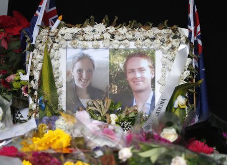 Photographs of Sydney's cafe siege victims, lawyer Katrina Dawson (L) and cafe manager Tori Johnson are displayed in a floral tribute near the site of the siege in Sydney's Martin Place, December 23, 2014. REUTERS/Jason Reed