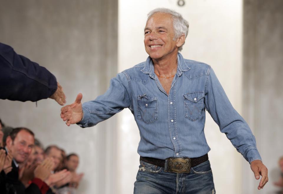 FILE - This Sept. 15, 2006 file photo shows designer Ralph Lauren shaking hands with an audience member after the showing of his spring 2007 collection in New York. Lauren recently celebrated his label’s 50th birthday, and a new HBO documentary, "Very Ralph," marks the occasion with a profile of the man who is the closest thing that America has to a national designer. (AP Photo/Richard Drew, File)