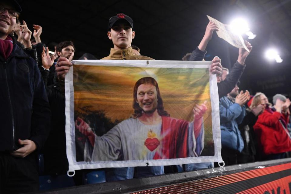 A fan of West Ham United holds up a banner in homage to manager David Moyes at Turf Moor.