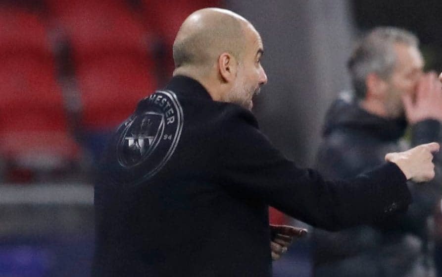 Pep Guardiola wears jacket with Man City emblem on back - REUTERS