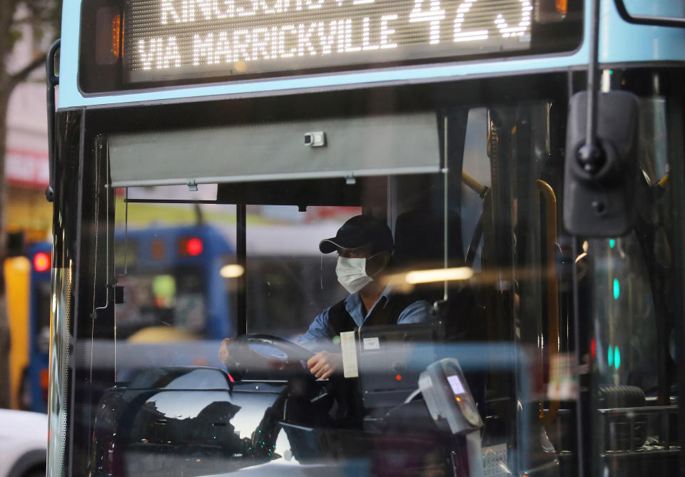 Photo shows a bus driver wearing a face mask in Sydney. Source: AAP