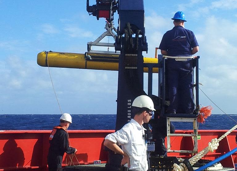 Staff from Phoenix International test the functionality of the Artemis autonomous underwater vehicle on the deck of Australian ship Ocean Shield, April 1, 2014