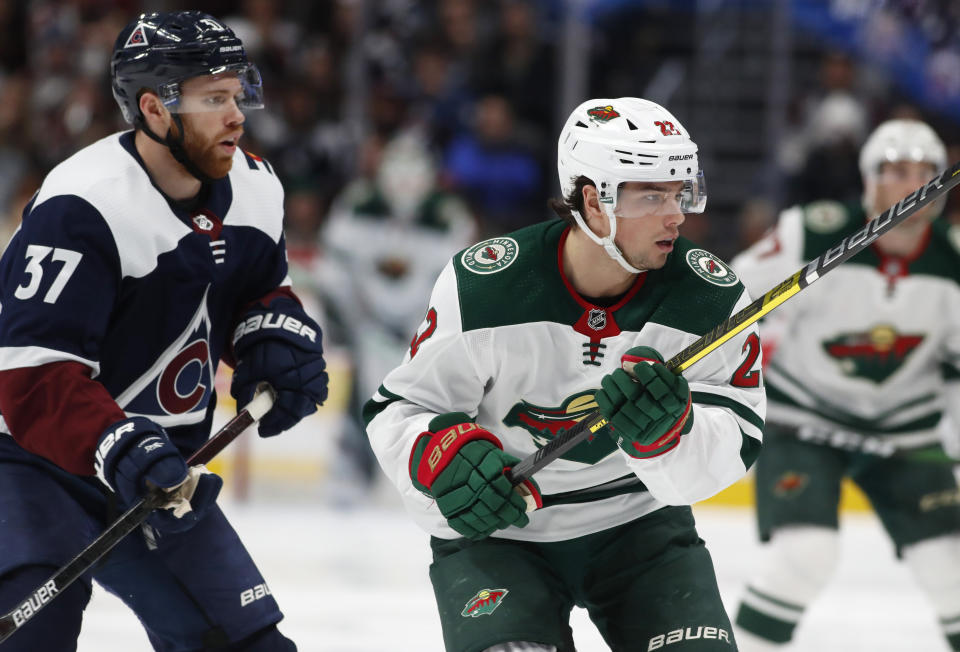 Minnesota Wild left wing Kevin Fiala, right, looks for a pass from a teammate as he drives past Colorado Avalanche left wing J.T. Compher, left, in the second period of an NHL hockey game Friday, Dec. 27, 2019, in Denver. (AP Photo/David Zalubowski)