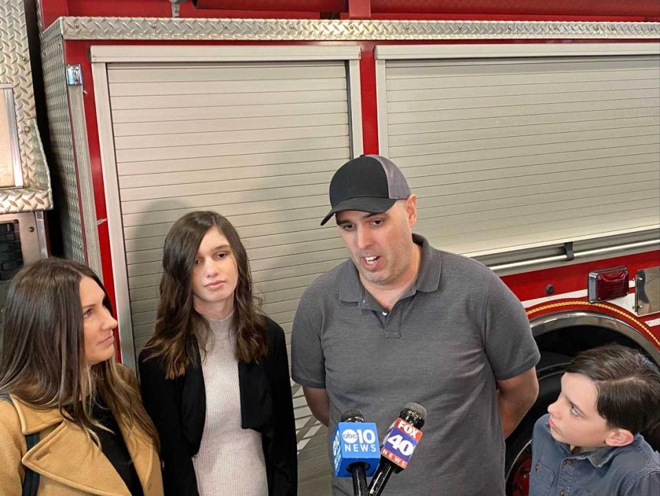 Brett Martin, center, speaks with reporters Wednesday after he was saved by Sacramento firefighters and city utilities workers from imminent brain death in December. He is surrounded by his wife, Katie Martin, far left; and children Natalie Martin, 14, and Schuyler Martin, 11.