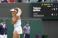 Germany's Tatjana Maria celebrates defeating Germany's Jule Niemeier in a women's singles quarterfinal match at the Wimbledon tennis championships in London, Tuesday July 5, 2022. (AP Photo/Kirsty Wigglesworth)