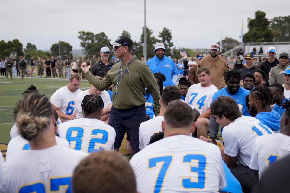 Coach Jim Harbaugh talks to his Chargers at Marine Corps Base Camp Pendleton.