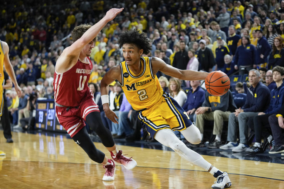 Michigan guard Kobe Bufkin (2) drives on Wisconsin guard Max Klesmit (11) in overtime of an NCAA college basketball game in Ann Arbor, Mich., Sunday, Feb. 26, 2023. (AP Photo/Paul Sancya)