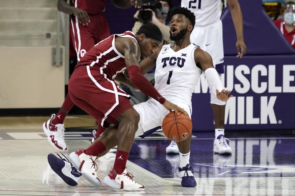 Oklahoma guard De'Vion Harmon (11) collides with TCU's Mike Miles (1) as he works the perimeter in the second half of an NCAA college basketball game in Fort Worth, Texas, Sunday, Dec. 6, 2020. (AP Photo/Tony Gutierrez)