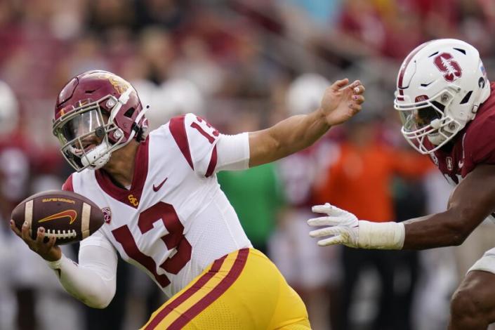 Stanford linebacker Ricky Miezan, right, chases down Southern California quarterback Caleb Williams.