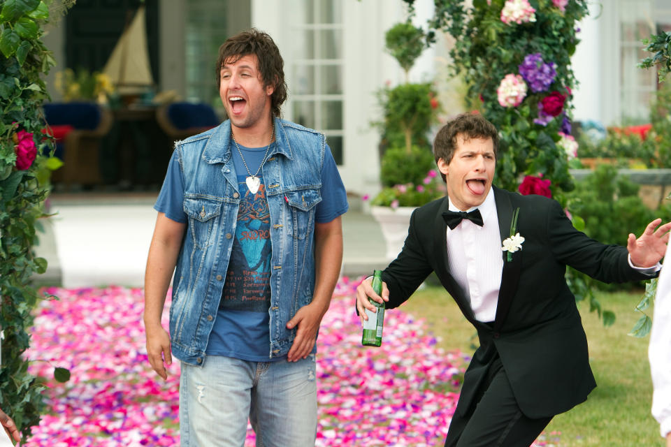 Adam Sandler in denim and Andy Samberg in a tux acting goofy in a scene