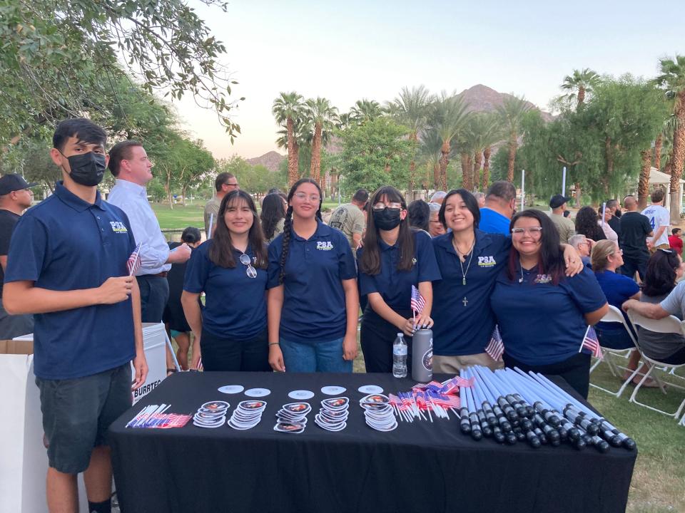 Members of the La Quinta High School Public Service Academy at a table with stickers of Marine Cpl. Hunter Lopez , American flags and lightsabers on Aug. 26, 2022.