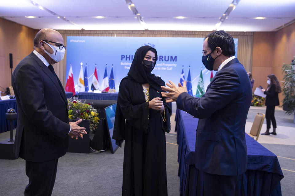 Bahrain's Foreign Minister Abdullatif Al-Zayani, left, Reem Ebrahim Al-Hashimi, Emirati Minister of State for International Cooperation, centrer and Cypriot Foreign Minister Nicos Christodoulides, speak during a meeting , in Athens, on Thursday, Feb. 11, 2021. Foreign ministers and senior officials from several Persian Gulf countries met in Athens, as Greece seeks to expand alliances to counter tension with regional rival Turkey. (AP Photo/Petros Giannakouris)