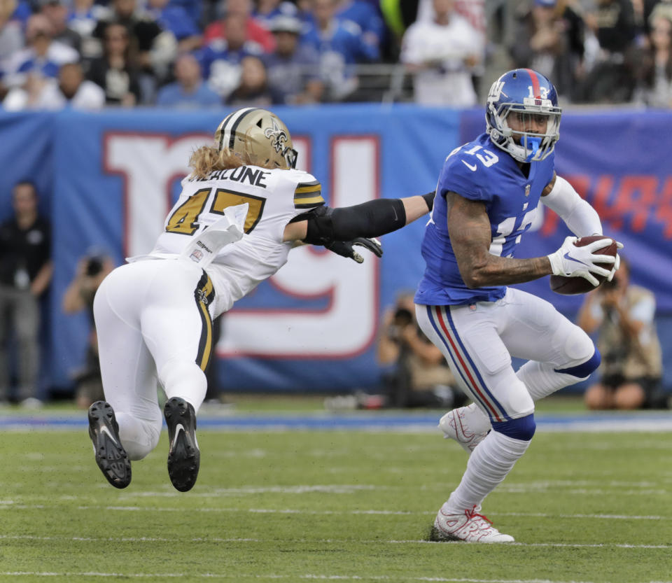 New Orleans Saints' Alex Anzalone, left, tries to grab New York Giants' Odell Beckham during the first half of an NFL football game, Sunday, Sept. 30, 2018, in East Rutherford, N.J. (AP Photo/Julio Cortez)