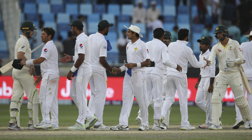 Pakistan players shake hands with Australian batsmen at the end of their test match in Dubai, United Arab Emirates, Thursday, Oct. 11, 2018. (AP Photo/Kamran Jebreili)