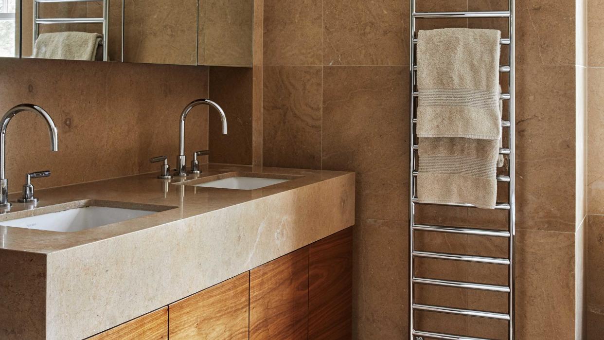  bathroom with warm neutral tiles and countertops 