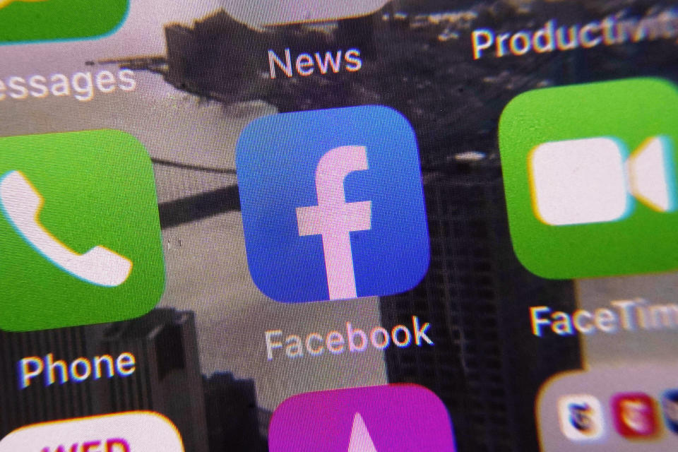 The Facebook app, center, is shown on a mobile phone screen, Wednesday, Jan. 25, 2023, in New York. Facebook parent Meta is reinstating former President Donald Trump's personal account after two-year suspension following the Jan. 6 insurrection, adding "new guardrails" to ensure there are no "repeat offenders" who violate its rules. (AP Photo/Richard Drew)