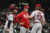 St. Louis Cardinals pitching coach Mike Maddux talks to John Gant and Yadier Molina during the third inning of a baseball game against the Milwaukee Brewers Wednesday, May 12, 2021, in Milwaukee. (AP Photo/Morry Gash)