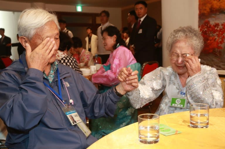 South Korean Kim Byung-oh (L), 88, cries with his North Korean sister Kim Sun Ok, 81, as they bid farewell