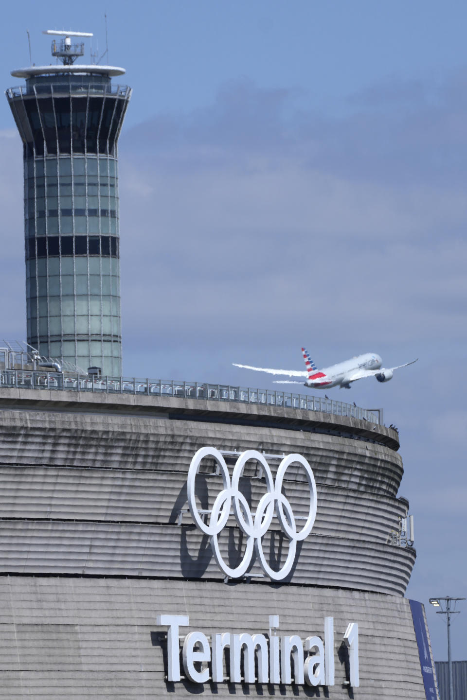 A plane takes off from Charles de Gaulle airport where the olympic rings were installed on terminal 1, in Roissy-en-France, north of Paris, Tuesday, April 23, 2024 in Paris. (AP Photo/Thibault Camus)