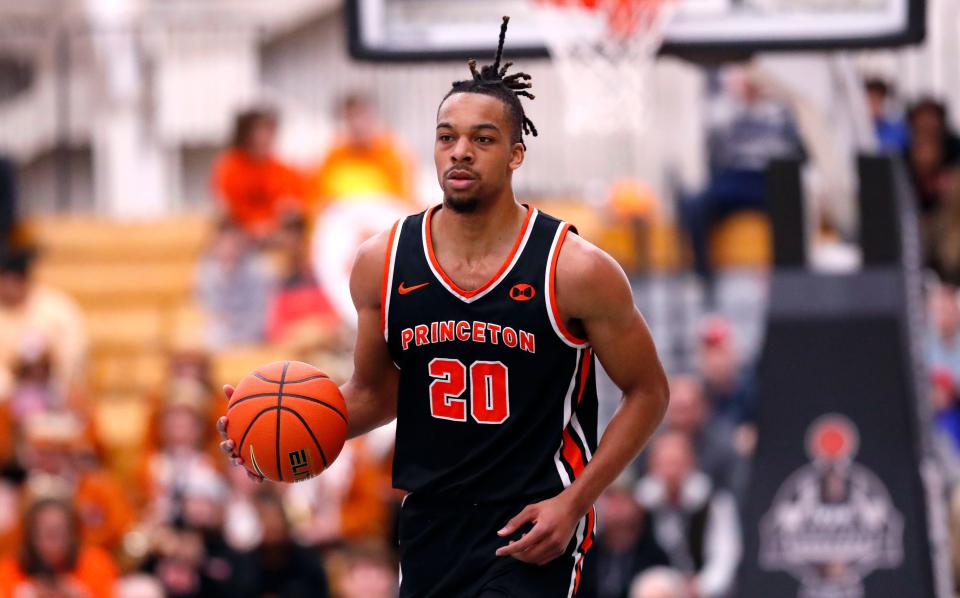 Princeton forward Tosan Evbuomwan (20) dribbles the ball against Yale during the first half of the Ivy League championship NCAA college basketball game, Sunday, March 12, 2023 in Princeton, N.J.