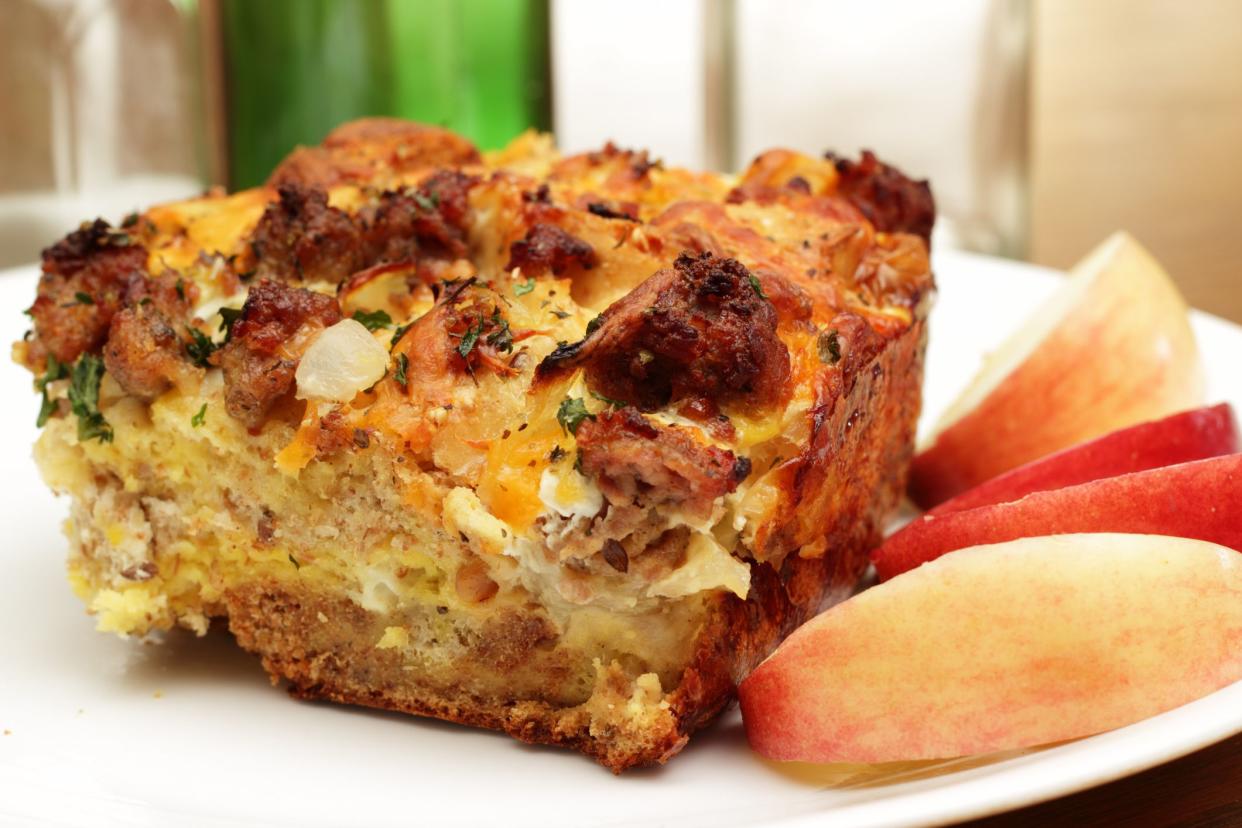 A bread pudding casserole made from French baguette bread, sage breakfast sausage, onions and cheddar cheese