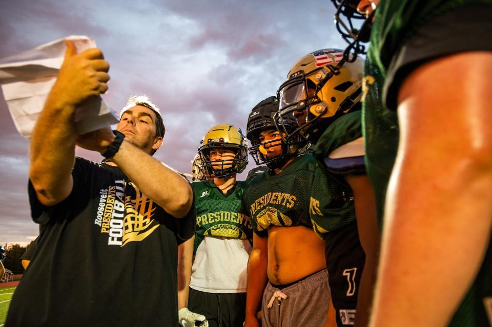 Assistant coach John McFarland, left, goes over a play in a huddle during football practice at FDR High School in Staatsburg, NY on Wednesday, August 24, 2022. KELLY MARSH/FOR THE POUGHKEEPSIE JOURNAL