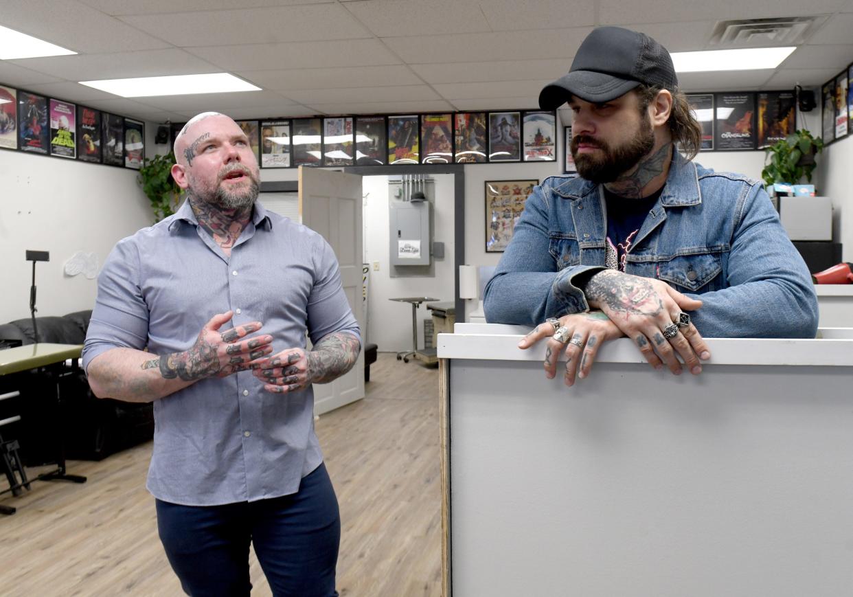 Rex Runner, left, owner of Pride and Glory Tattoos & Piercings in Perry Township, recalls the day in August 2022 when he found his best friend, Shane Altimore, right, lying in bed nearly unconscious after suffering a stroke. Altimore now works as a barber at Runner's shop.