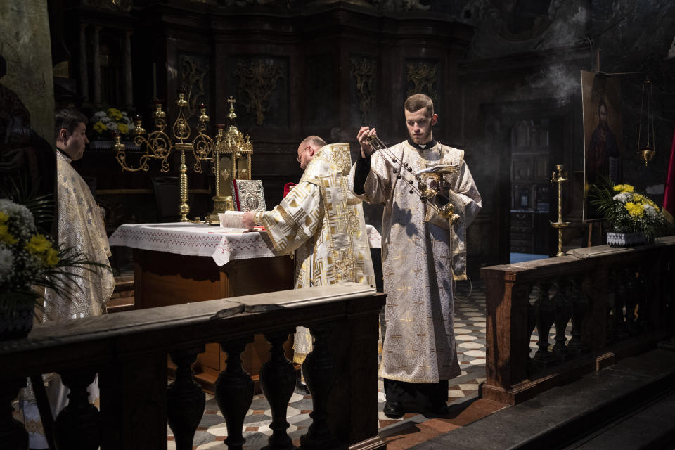 Ukrainian Greek Catholic priests celebrate Sunday mass in the Saints Peter and Paul Garrison Church in Lviv, western Ukraine, Sunday, March 6, 2022. (AP Photo/Bernat Armangue)