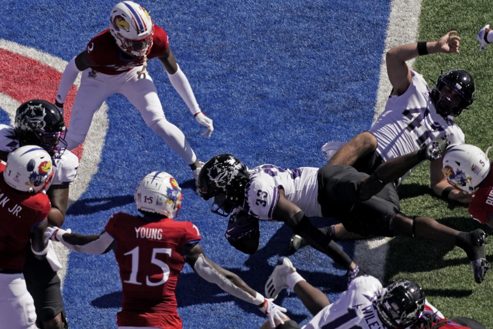 TCU running back Kendre Miller (33) dives into the end zone to score a touchdown during the first half of an NCAA college football game against Kansas Saturday, Oct. 8, 2022, in Lawrence, Kan. (AP Photo/Charlie Riedel)